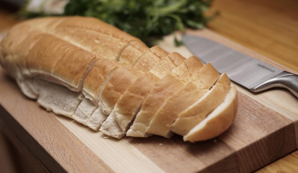 food, bread, knife, sliced bread, cutting board, italian bread, loaf, kitchen, cooking, kitchenware, wood cutting board, food, bread, cutting board, cutting board, italian bread, italian bread, italian bread, italian bread, italian bread